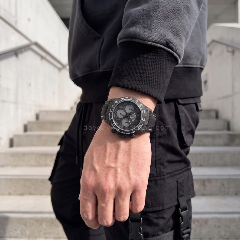 Rolex with black band on wrist