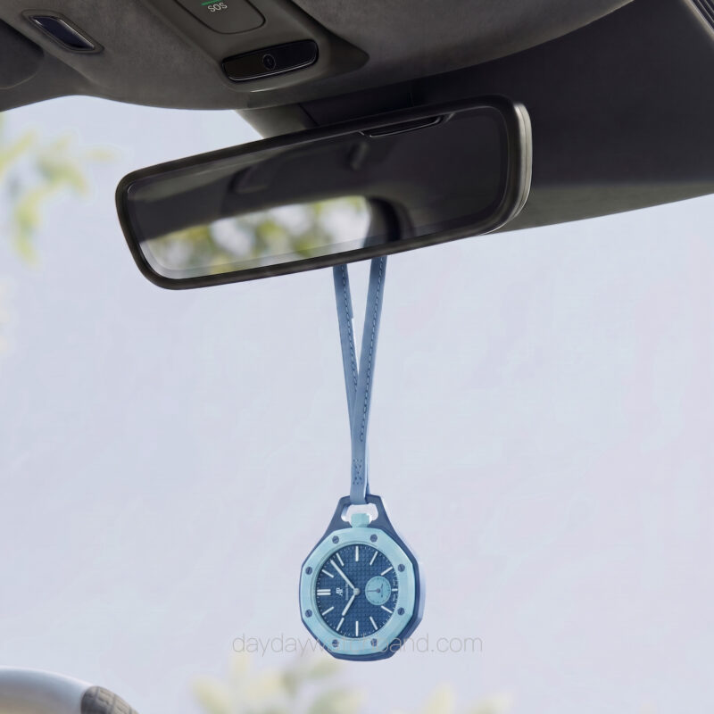 Light blue neck strap for AP Swatch Royal Pop hanging from car rearview mirror — leather lanyard for Swatch AP Royal Pop used as stylish car accessory display