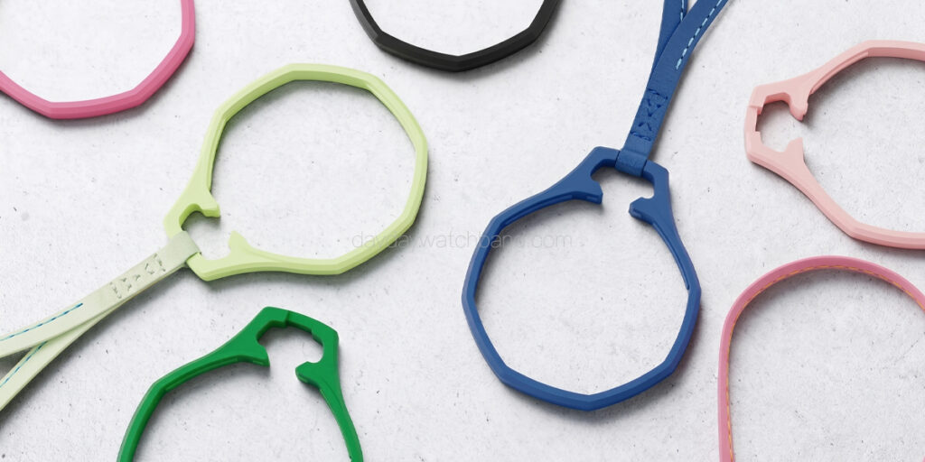 Multicolor leather strap holder for Royal Pop flatlay — green, blue, pink, black octagonal ring and lanyard for Swatch AP Royal Pop scattered on light grey surface