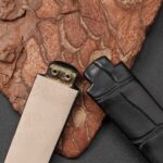 Detail shot of bespoke watch straps for Ebel Beluga showing curved brass end link on calfskin lining side versus alligator exterior