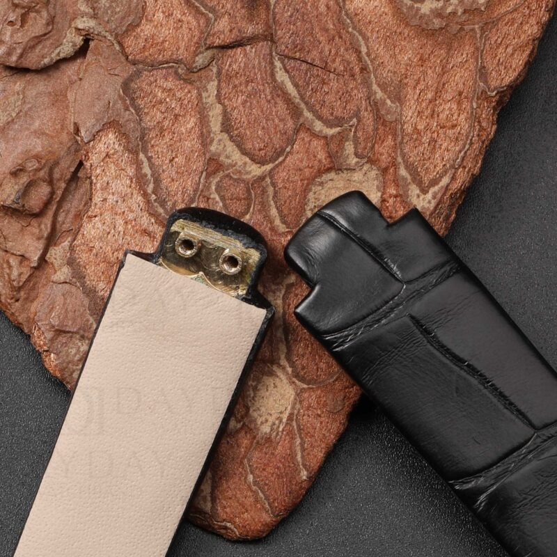 Detail shot of bespoke watch straps for Ebel Beluga showing curved brass end link on calfskin lining side versus alligator exterior