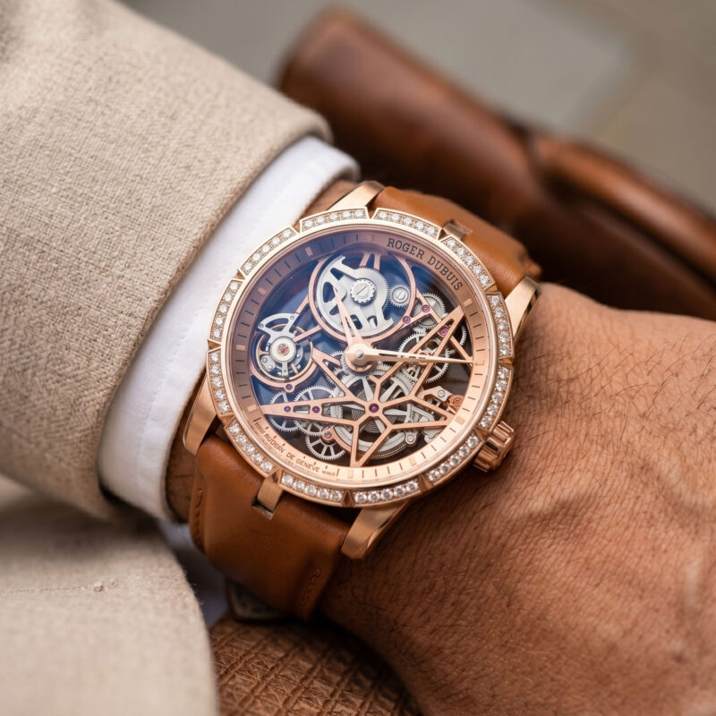 Watch strap for Roger Dubuis Excalibur in calfskin worn on wrist with rose gold diamond skeleton Excalibur watch