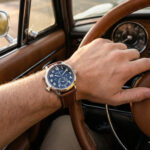 Patek Philippe Calatrava Pilot Travel Time 5524 with brown calfskin leather strap on wrist while driving a vintage car