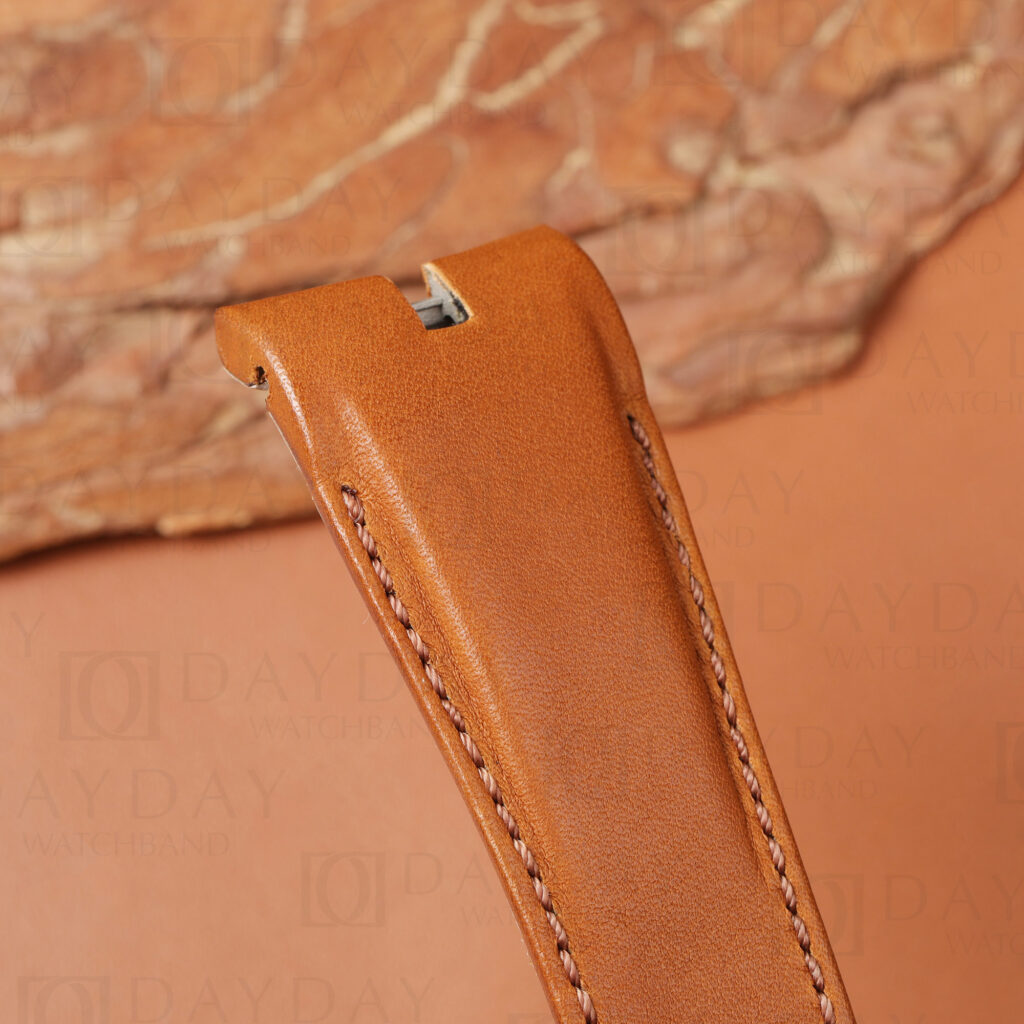 Close-up of leather watch strap for Roger Dubuis Excalibur showing curved lug end cutout and quick-release slot on cognac calfskin