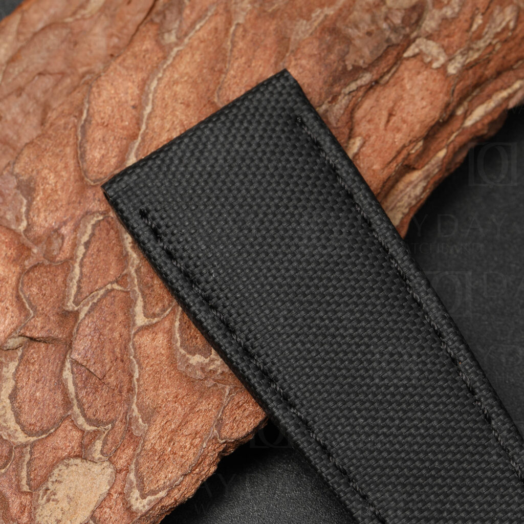 Close-up of high-density nylon weave texture on sailcloth strap for Cartier Calibre, showing structured surface pattern