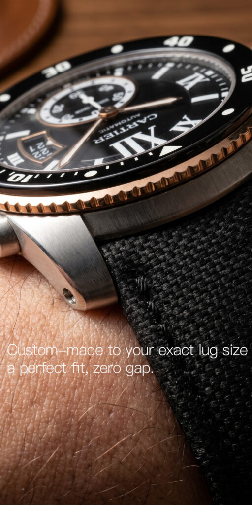 Close-up of black sailcloth watch strap for Cartier Calibre de Cartier showing perfect lug fit with zero gap between strap and case